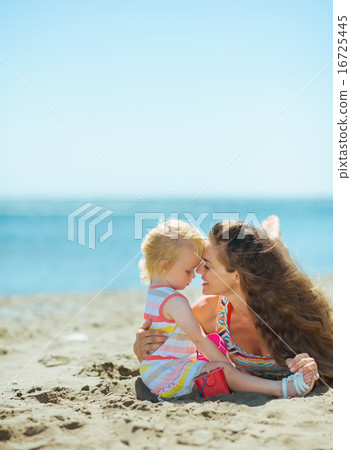 Mother and baby girl playing on beach Mother and baby girl playing on beach 16725445
