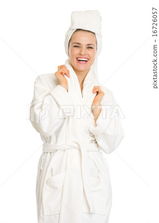 Portrait of smiling young woman in bathrobe 16726057