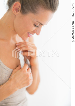 Happy young woman holding pregnancy test Happy young woman holding pregnancy test 16726578