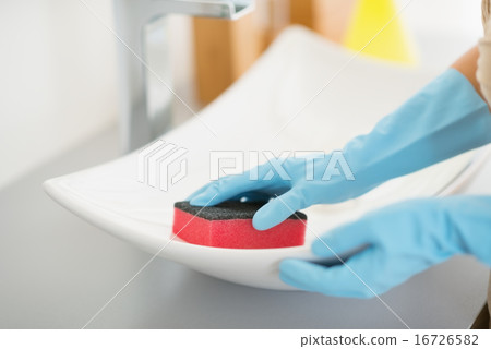 Closeup on housewife cleaning sink with sponge Closeup on housewife cleaning sink with sponge 16726582
