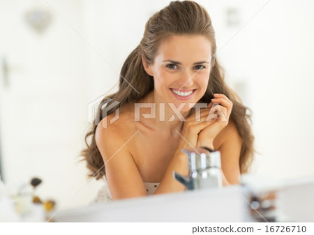 Portrait of smiling young woman in bathroom Portrait of smiling young woman in bathroom 16726710