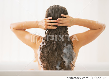 Stock Photo: Young woman washing hair. rear view