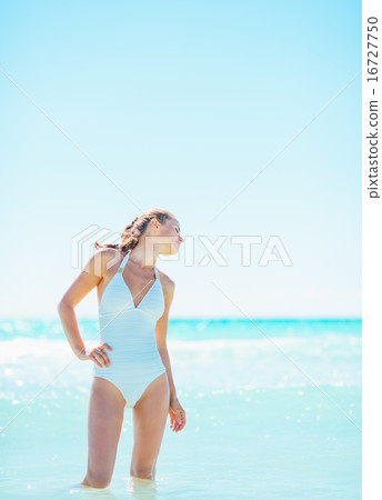 Portrait of relaxed young woman at seaside 16727750