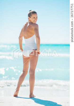 Full length portrait of young woman standing on beach 16727751