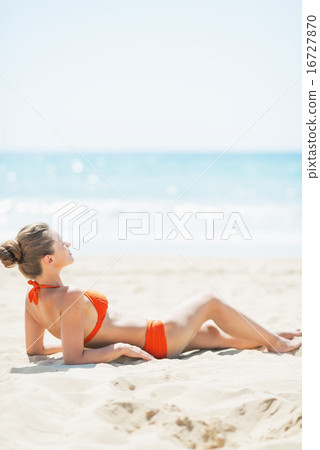 Relaxed young woman laying on beach Relaxed young woman laying on beach 16727870