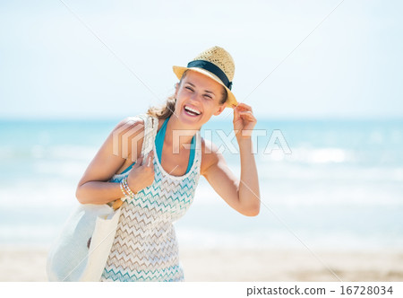 Happy young woman in hat on beach Happy young woman in hat on beach 16728034