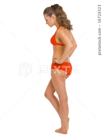 Full length portrait of thoughtful young woman in swimsuit . rea Full length portrait of thoughtful young woman in swimsuit . rea 16728323