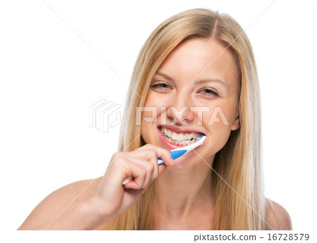 Smiling young woman brushing teeth Smiling young woman brushing teeth 16728579