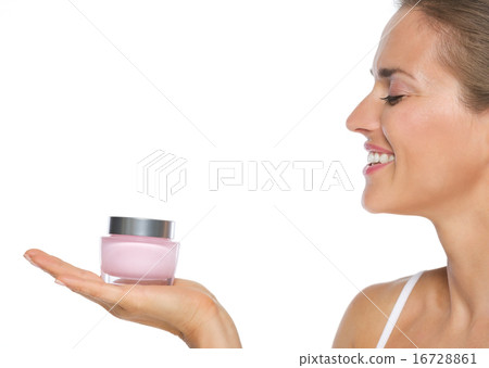 Profile portrait of smiling young woman showing creme Profile portrait of smiling young woman showing creme 16728861