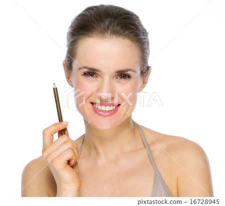 Beauty portrait of smiling young woman holding brown eye liner Beauty portrait of smiling young woman holding brown eye liner 16728945