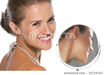 Portrait of smiling young woman with mirror Portrait of smiling young woman with mirror 16729103