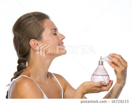 Young woman applying perfume 16729215