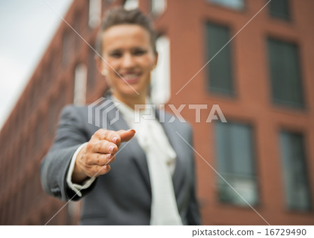 Closeup on happy business woman stretching hand for handshake in Closeup on happy business woman stretching hand for handshake in 16729490