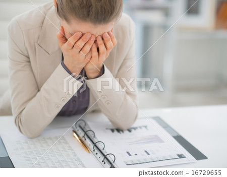 Frustrated business woman working with documents in office 16729655