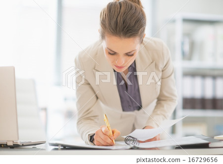 Business woman working in office with documents 16729656