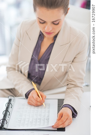 Portrait of business woman writing in document Portrait of business woman writing in document 16729907