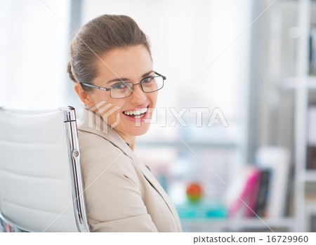 Portrait of happy business woman wearing eyeglasses at work Portrait of happy business woman wearing eyeglasses at work 16729960