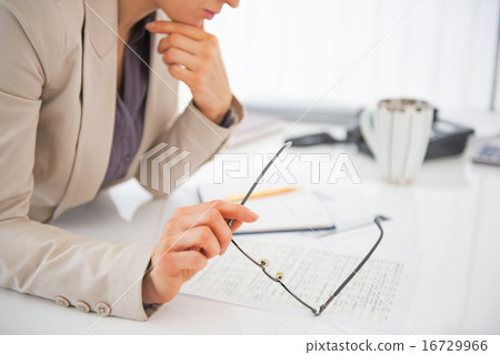 Closeup on eyeglasses in hand of business woman Closeup on eyeglasses in hand of business woman 16729966