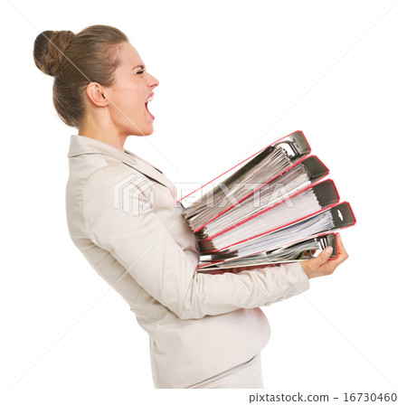 Frustrated business woman holding stack of folders Frustrated business woman holding stack of folders 16730460
