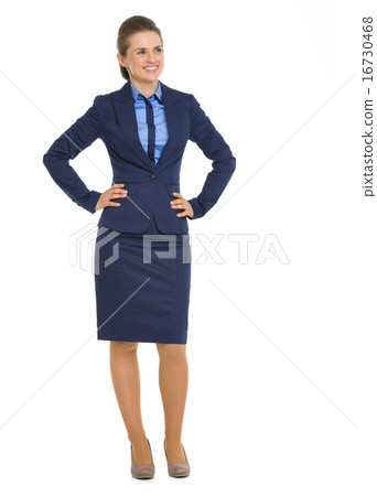 Full length portrait of smiling business woman looking on copy s 16730468