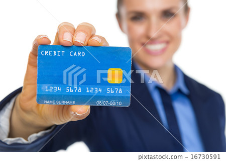 Closeup on smiling business woman showing credit card 16730591
