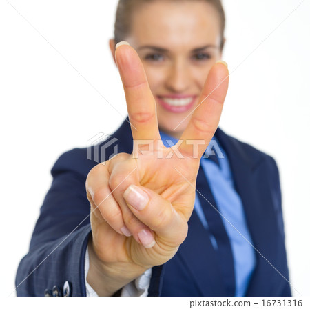 Closeup on happy business woman showing victory gesture Closeup on happy business woman showing victory gesture 16731316