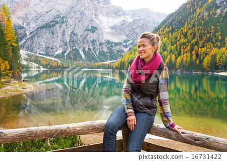 Portrait of happy young woman on lake braies in south tyrol, ita 16731422