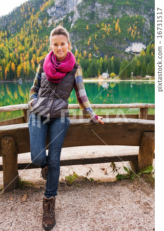 Woman hiker rests at edge of Lake Bries with pink scarf 16731517