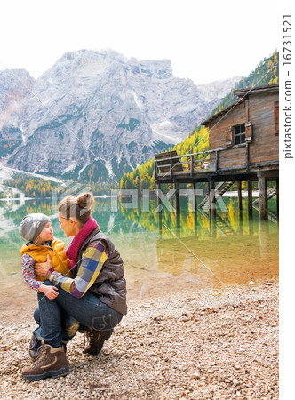 Happy mother and baby on lake braies in south tyrol, italy Happy mother and baby on lake braies in south tyrol, italy 16731521
