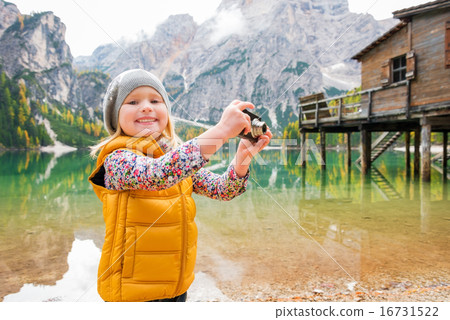 Young blonde girl smiling at Lake Bries and playing with camera Young blonde girl smiling at Lake Bries and playing with camera 16731522