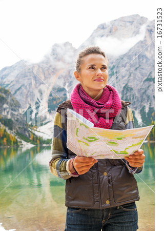 Young woman with map on lake braies in south tyrol, italy Young woman with map on lake braies in south tyrol, italy 16731523