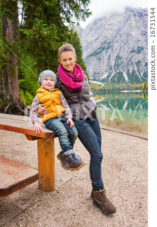 Mother and daughter resting at wooden picnic table on Lake Bries 16731544