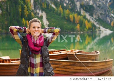 Woman hiker with hands behind her head relaxes on Lake Bries Woman hiker with hands behind her head relaxes on Lake Bries 16731546