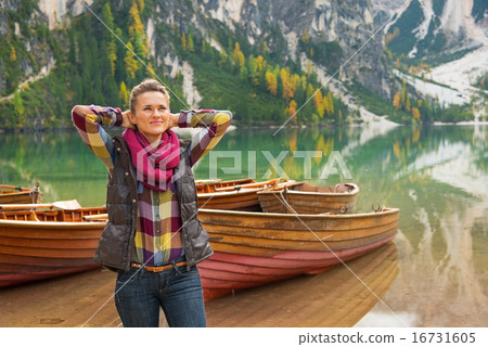 Portrait of relaxed young woman on lake braies in south tyrol, i 16731605