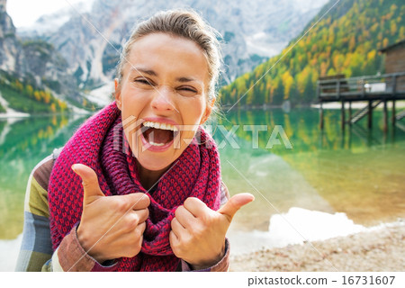 Portrait of happy young woman on lake braies in south tyrol, ita 16731607