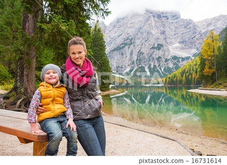 Portrait of happy mother and baby on lake braies in south tyrol, 16731614