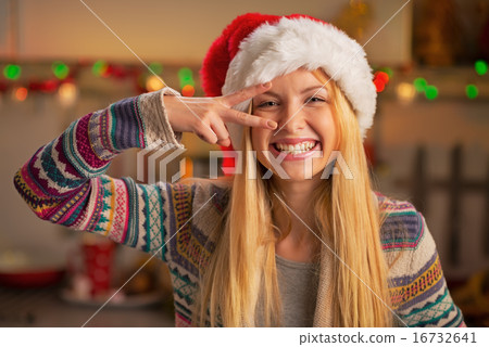 Portrait of happy teenager girl in santa hat having fun time Portrait of happy teenager girl in santa hat having fun time 16732641