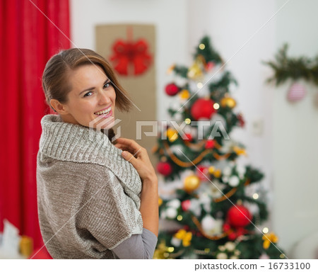 Portrait of happy young woman near Christmas tree Portrait of happy young woman near Christmas tree 16733100