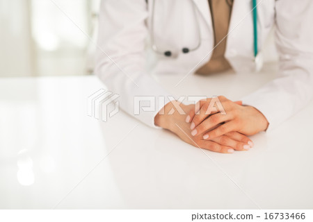 Closeup on medical doctor woman sitting at table 16733466