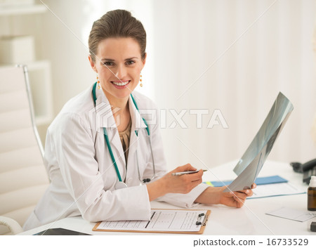 Portrait of happy doctor woman holding fluorography in office Portrait of happy doctor woman holding fluorography in office 16733529