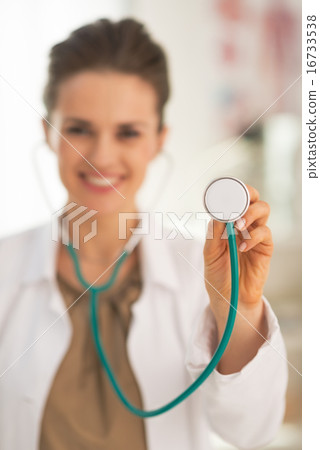 Closeup on doctor woman using stethoscope Closeup on doctor woman using stethoscope 16733538