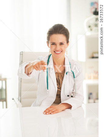 Medical doctor woman pointing in camera Medical doctor woman pointing in camera 16733572