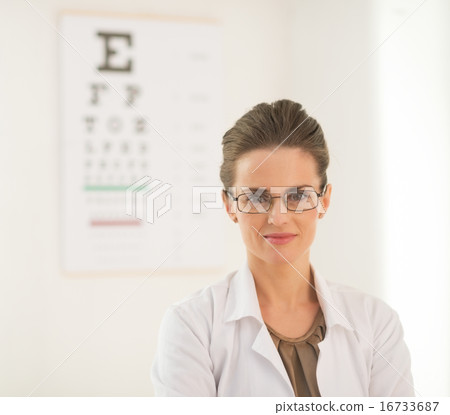 Portrait of ophthalmologist doctor woman in front of snellen cha Portrait of ophthalmologist doctor woman in front of snellen cha 16733687