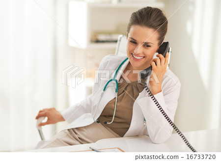 Happy doctor woman talking phone Happy doctor woman talking phone 16733720
