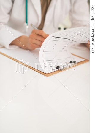 Closeup on doctor woman working in office 16733722