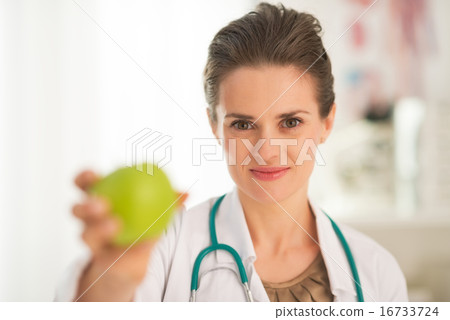Medical doctor woman giving apple Medical doctor woman giving apple 16733724