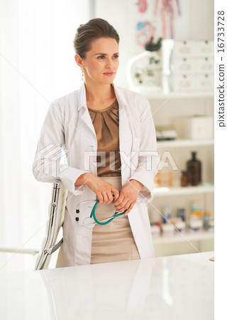 Portrait of thoughtful doctor woman in office Portrait of thoughtful doctor woman in office 16733728
