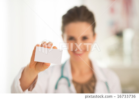 Closeup on happy medical doctor woman showing business card Closeup on happy medical doctor woman showing business card 16733736