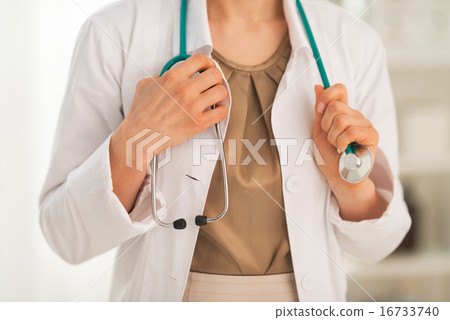 Closeup on medical doctor woman with stethoscope Closeup on medical doctor woman with stethoscope 16733740