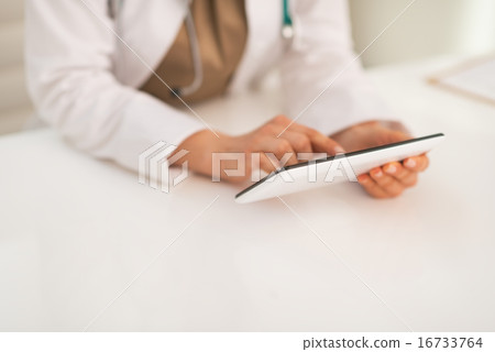 Closeup on medical doctor woman using tablet pc Closeup on medical doctor woman using tablet pc 16733764